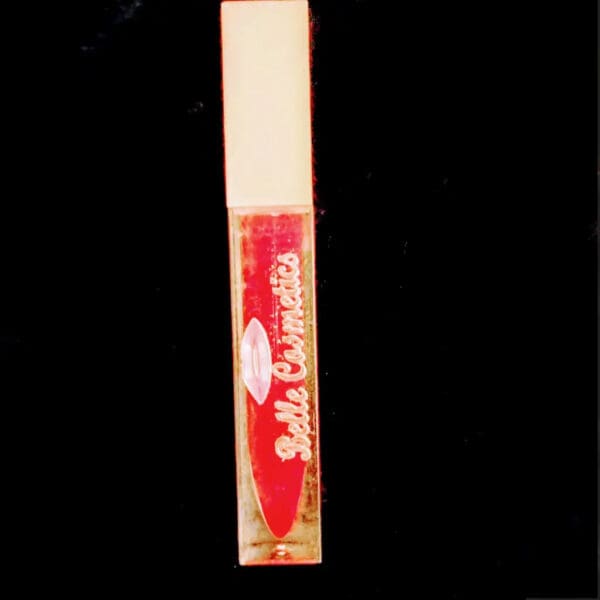 A red tube of lip gloss on top of a black background.