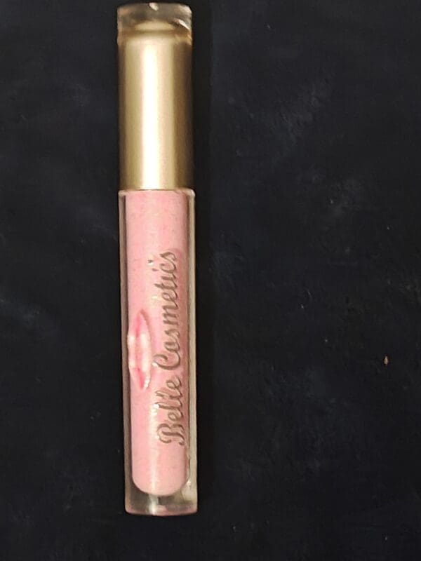 A close up of the lip gloss on a black background